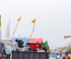 A group of women in a tractor-trolley, heading home after participating in the event at Singhu.