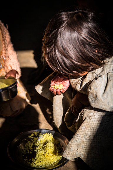 Mid-day meals are a huge incentive for children to attend the anganwadi. Kynja Babha (right) finishes her meal. Her day at the anganwadi has come to an end