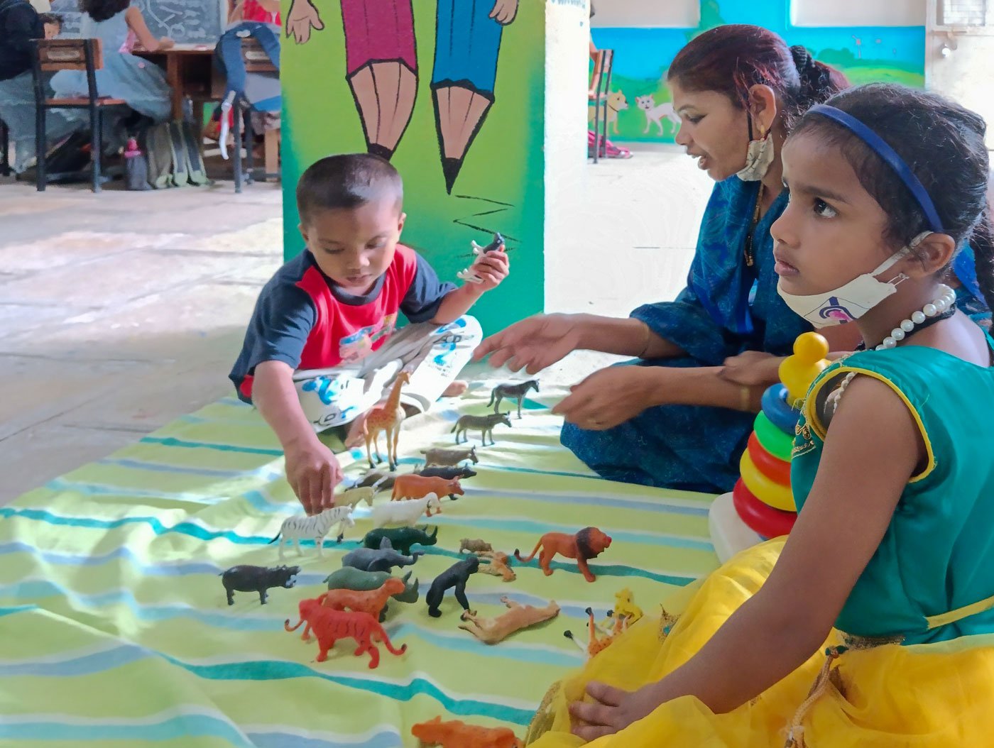 A hearing impaired child joined the hostel at the Dhayari school. Not yet five years old, he is learning the names of animals while playing with the rubber models