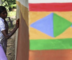 Women paints the walls during the festival