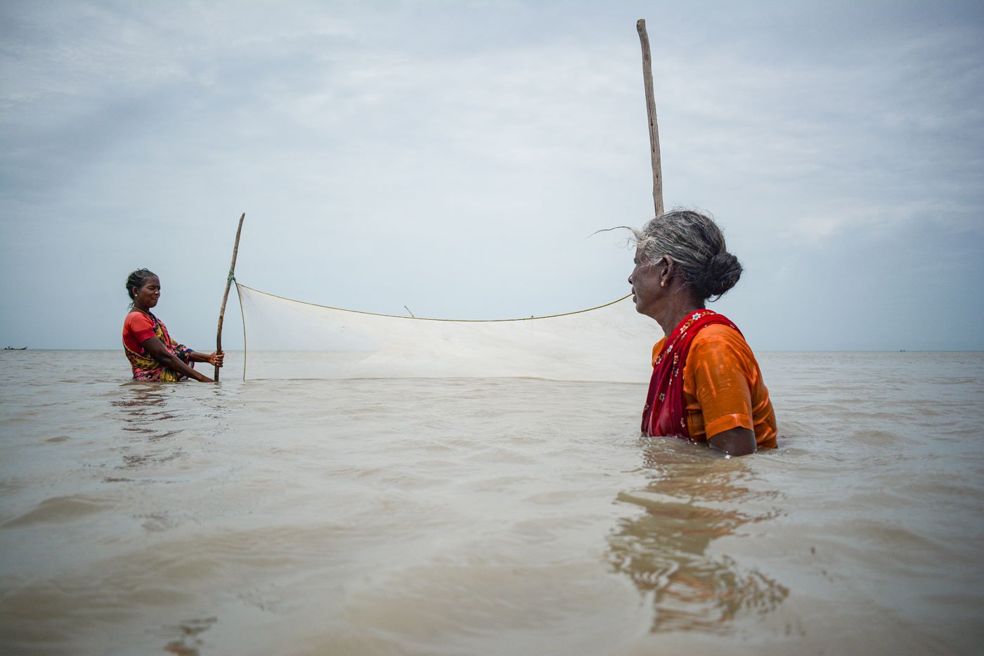 Indira Gandhi (in focus) ready to pull the prawn nets.