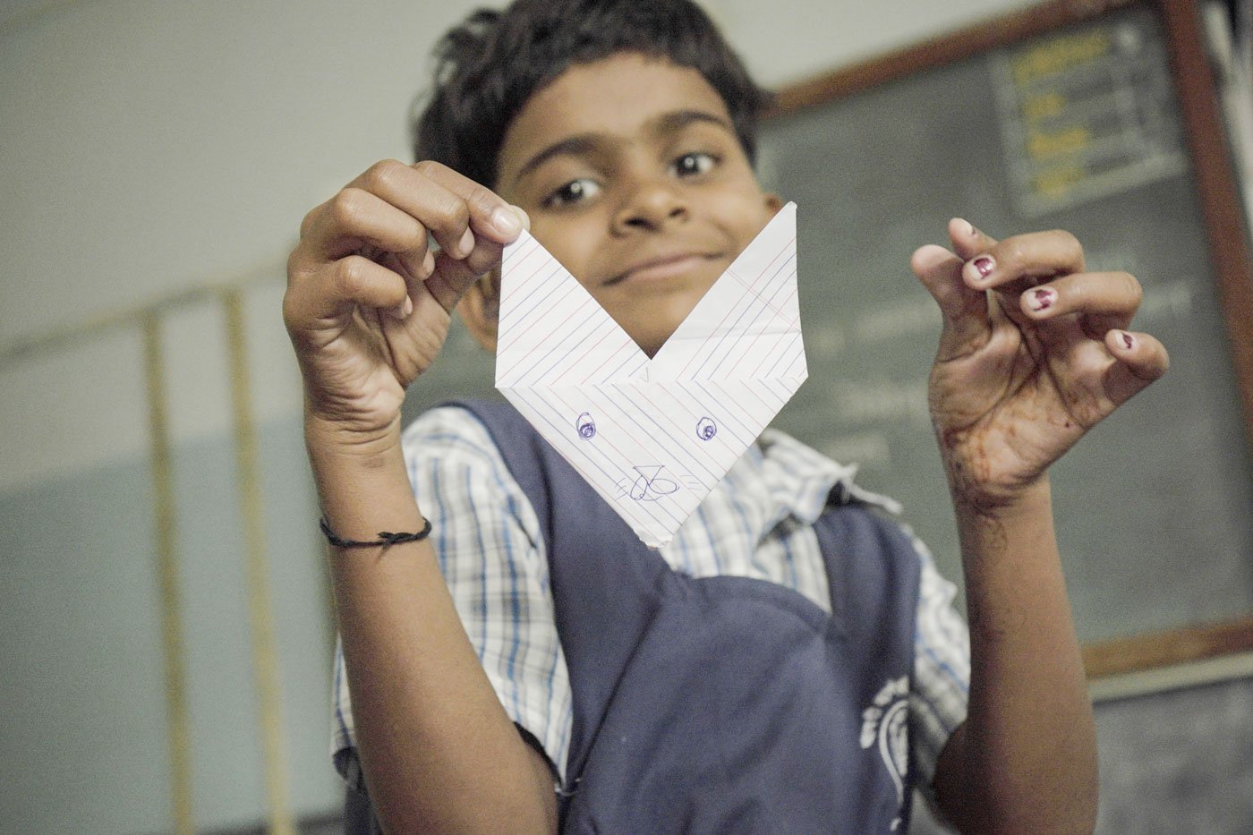 A child shows a paper bunny