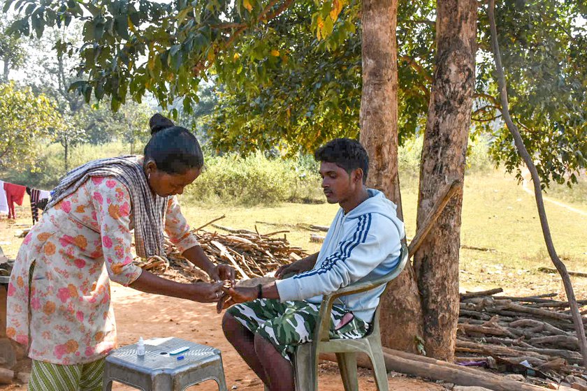 Administering a rapid malaria test on a patient