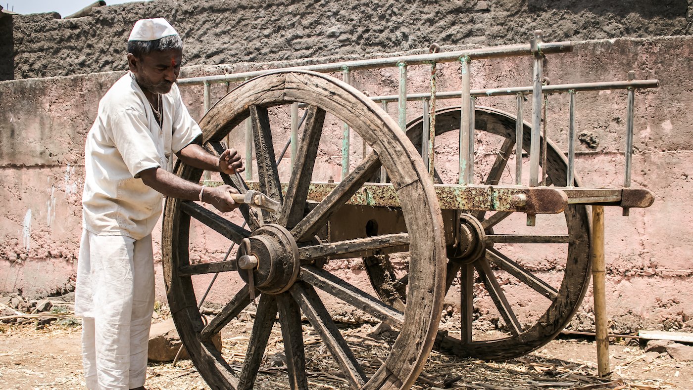 Man next to bullock cart he built