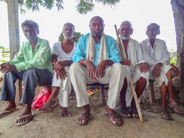 Deepak Warfade (wearing a blue kurta) lost his house and crops to the July floods. He's moved into a rented house in the village since then