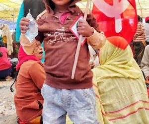 Little boy with red flag at Ramleela Maidan