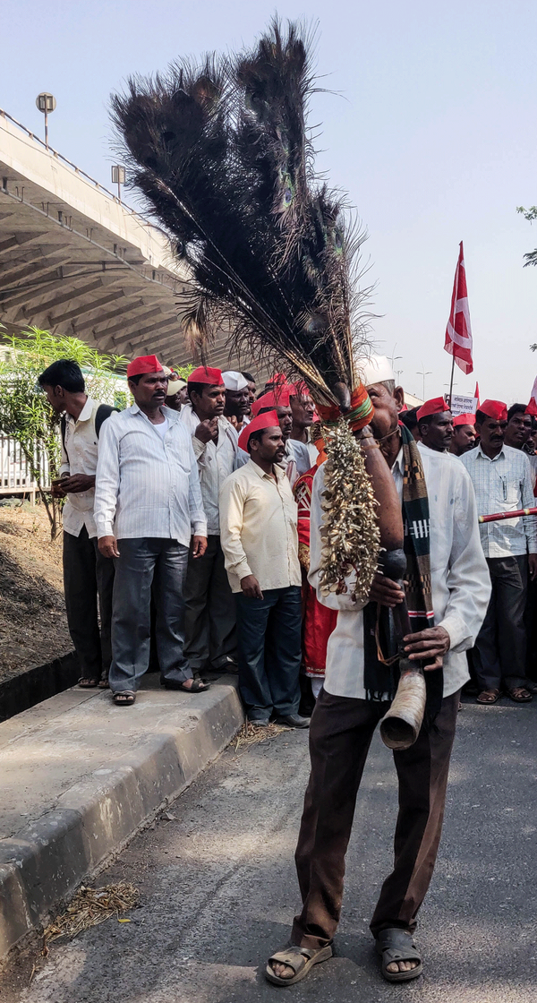 Vasant Sahare playing the pavri at the rally.