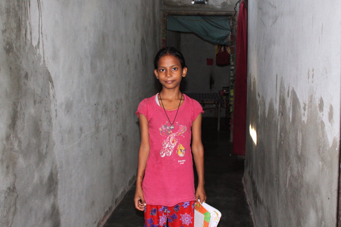 Kashish Ahaldhiya standing in a corridor