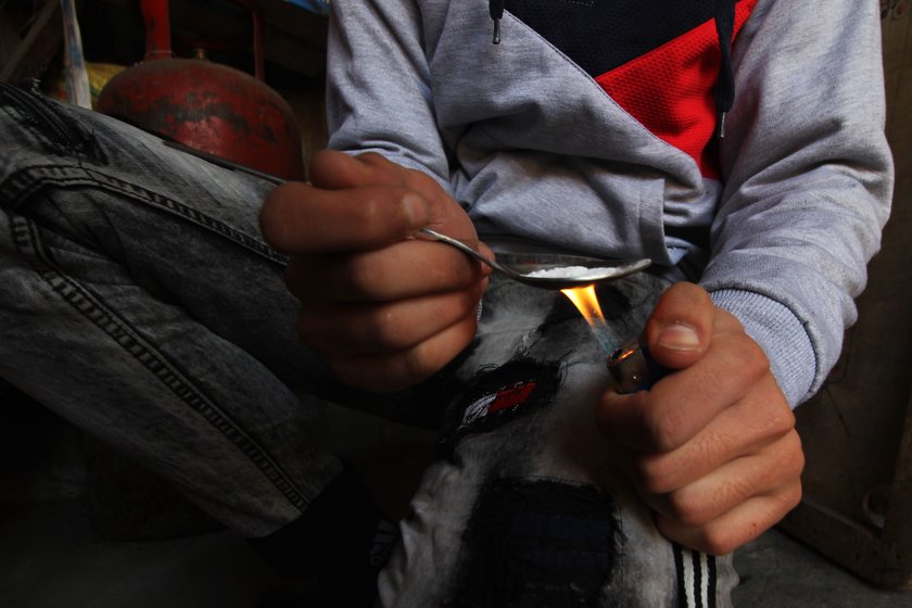 Left: A young boy in a village on the outskirts of Srinagar using heroin. 
