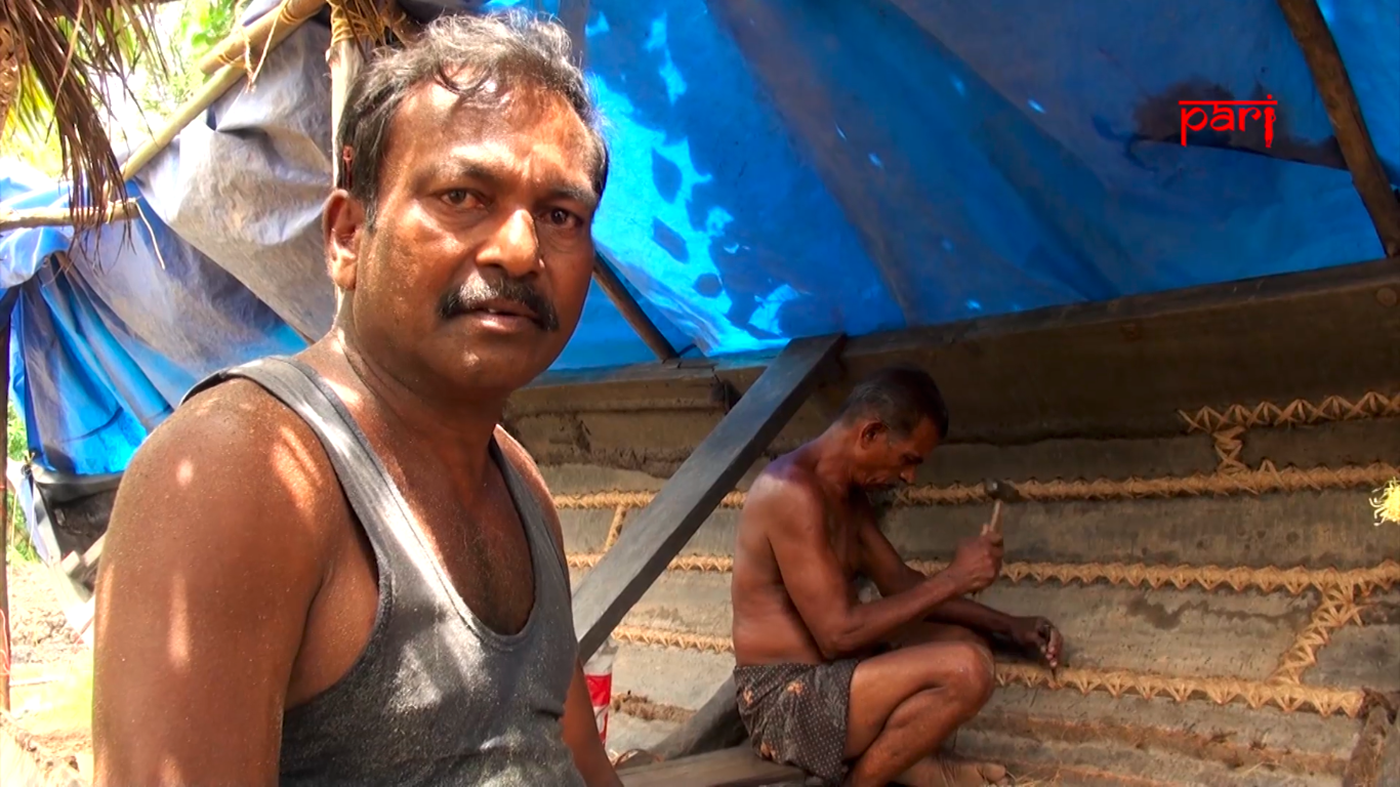 Two boat repairmen at work