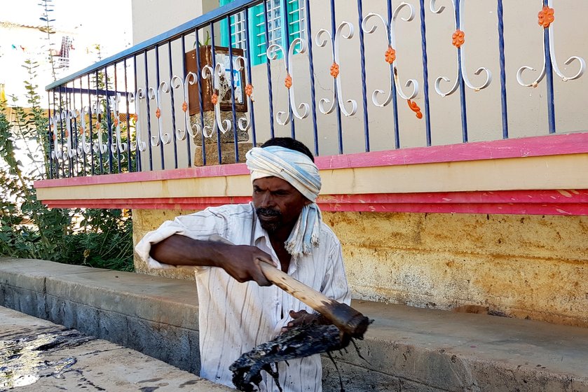 sanitation worker cleaning the gutter

