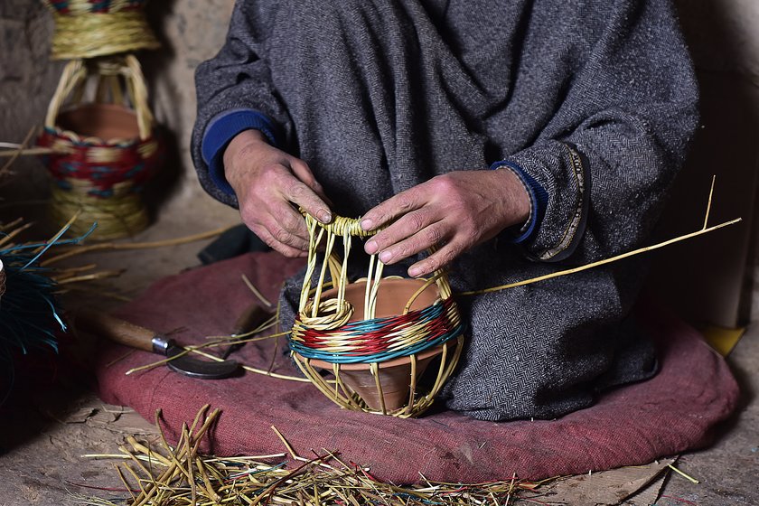 Left: Manzoor Ahmad, 40, weaving a colourful kangri at a workshop in Charar-i-Sharief in Badgam district. Right: Khazir Mohammad Malik, 86, weaving a monochromatic kangri in his workshop at Kanil mohalla in Charar-i-Sharief